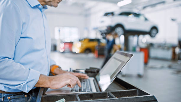 istock Male Auto Repair Shop Manager Working Using Laptop 1892179094