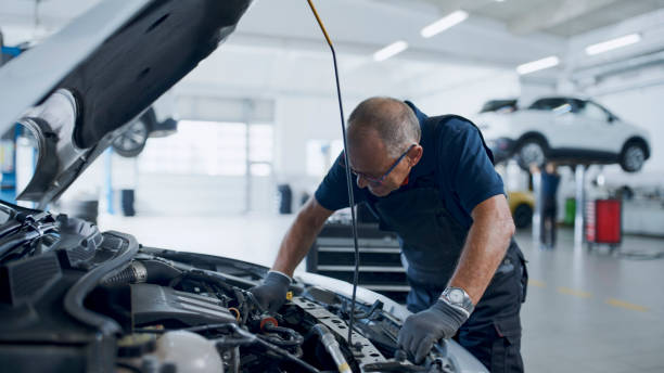 istock Expert Male Mechanic Examining Car Engine At Workshop 1892179633