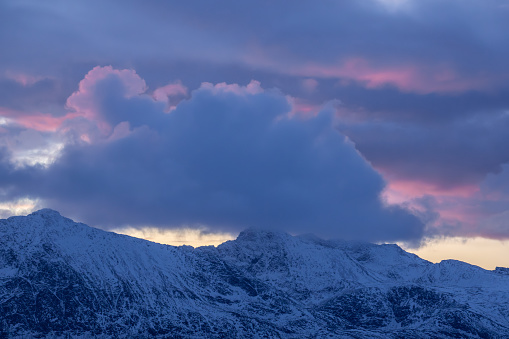 A purple sunset over the snowy mountains of Norway in the Arctic, hues of purple and blue
