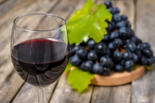 istock Red wine and grapes on wooden background 1892237949