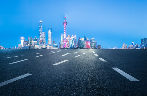 Asphalt road and city building landscape in Shanghai at night