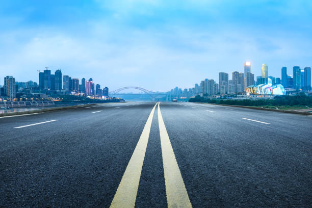 istock Empty asphalt road and city buildings skyline at night 1892246842