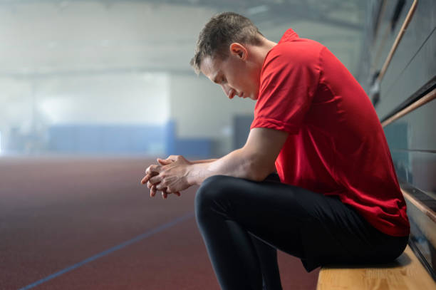 istock Despair man sitting in sports hall 1892280398