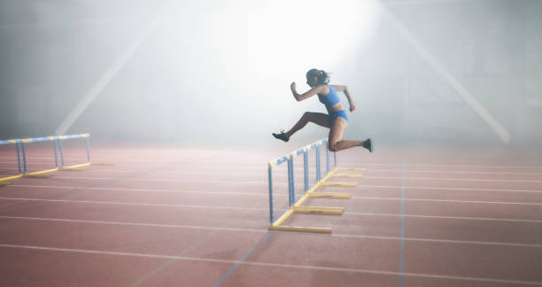 istock Athlete woman jumping over hurdle 1892280407