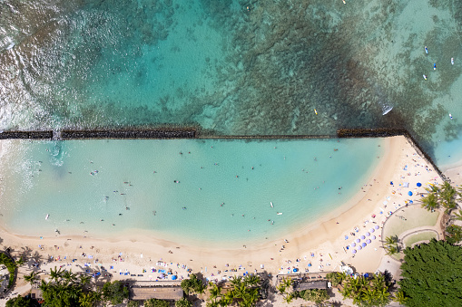 Overhead top view of man made Waikiki Beach in Honolulu, HI, showing it's wall wave barrier