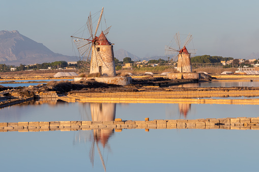 Sunset at Windmills in the salt evoporation pond in Marsala, Sicily island, Italy
Trapani salt flats and old windmill in Sicily.
View in beautifull sunny day.