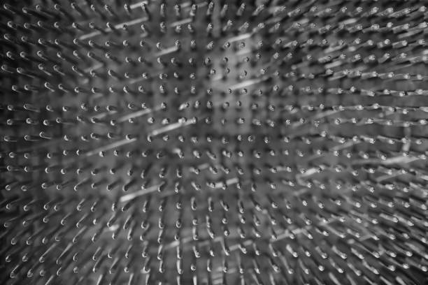 istock Bed of nails. Surface. Metal nails in rows. Top view. 1892360852