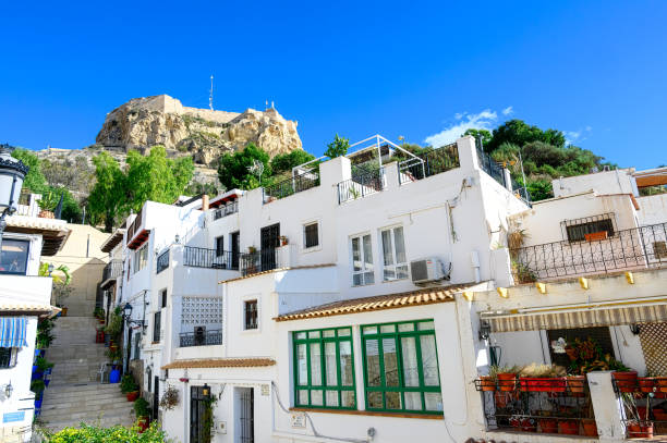 Alicante, Spain - Jan. 18, 2023: The Santa Barbara fort is framed in the Santa Cruz district which is a tourist attraction in the city.