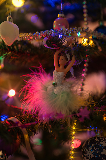 Dancing balerina toy among the Christmas tree decorations