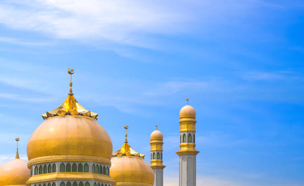 istock Golden mosques dome and towers against blue sky background 1892417527