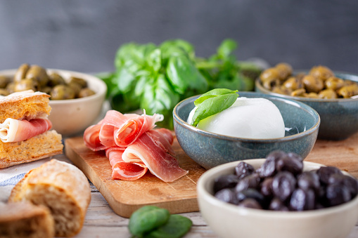 Antipasti - olives, ham, bread and buffalo mozzarella