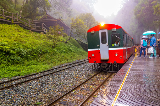 Alishan, Taiwan - October 08 2023 : Red Vintage Train inside Alishan National Forest Park