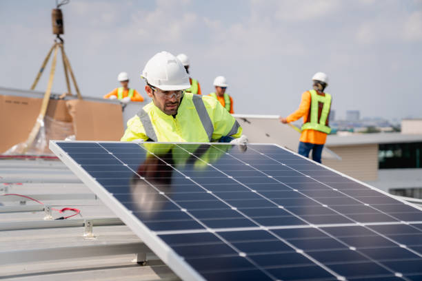 istock Service engineer installing solar cell on the roof of factory. Technicians working about solar panel system outdoors. Clean and Renewable energy concept. 1892548177
