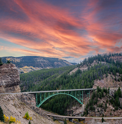 Red Cliff Bridge is located in Red Cliff, Colorado between Minturn and Leadville. Each Autumn, the Colorado Rocky Mountains create a dazzling and colorful display as the Aspens turn a brilliant yellow and glow against the mountains. In addition, their tall, vertical, trunks with white bark create a repetitive pattern under the foliage.