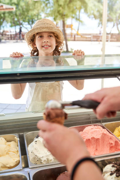 istock Cheerful boy near ice cream parlor 1892723103