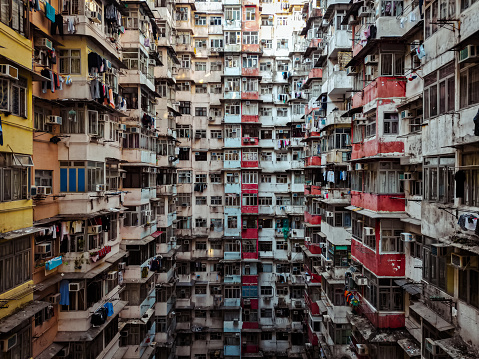 Discover the paradoxical beauty and challenges of urban living in Hong Kong's famed Monster Building, where numerous families carve out their existence in compact quarters, stacking stories upon stories. In this vertical cityscape, the iconic structure embodies the juxtaposition of modernity and communal resilience. The drone captures the intricate web of windows, each framing a unique narrative of daily life amidst the bustling metropolis. A testament to the adaptability of its residents, this photo series offers a poignant glimpse into the complexities of high-density living in one of the world's most vibrant cities.