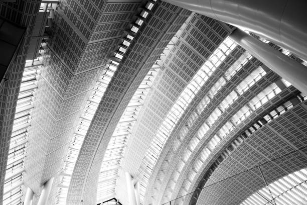 istock Black and white photo of modern architecture, modern architecture print, natural light shining through building 1892729819