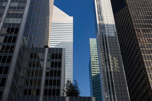 Looking up at a variety of office buildings and skyscrapers in Midtown Manhattan of New York City