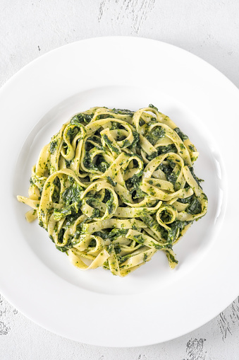 Creamy spinach tagliatelle pasta on the plate