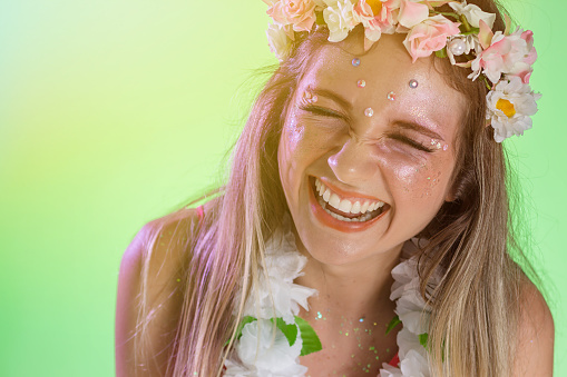Carnaval Brazil. Excited and Cheerful. Face of brazilian blonde woman wearing carnival costume. Bright background. Party concept, celebration and festival.
