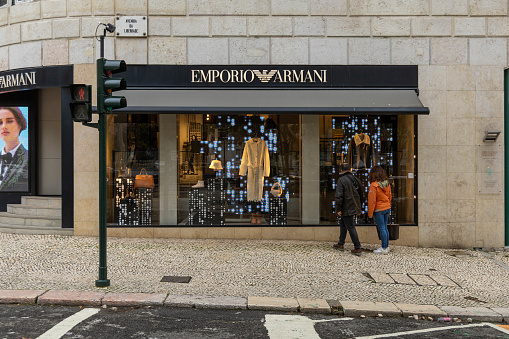 Lisbon, Portugal. 8 December 2023. Emporio Armani logo sign at the shop. Giorgio Armani is an international Italian fashion house, specialized in design and production
