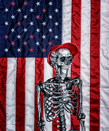 Red hat soulless skeleton on a USA American flag background with several red state stars. Empty GOP promises, soulless Republican Party