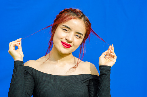 beautiful Redhead young woman posing with blue background