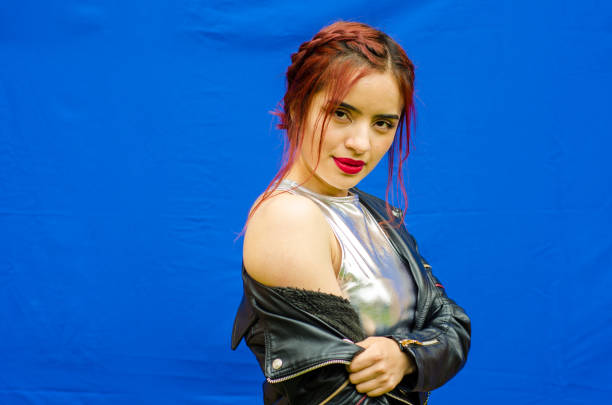 istock beautiful Redhead young woman posing with blue background 1892898438