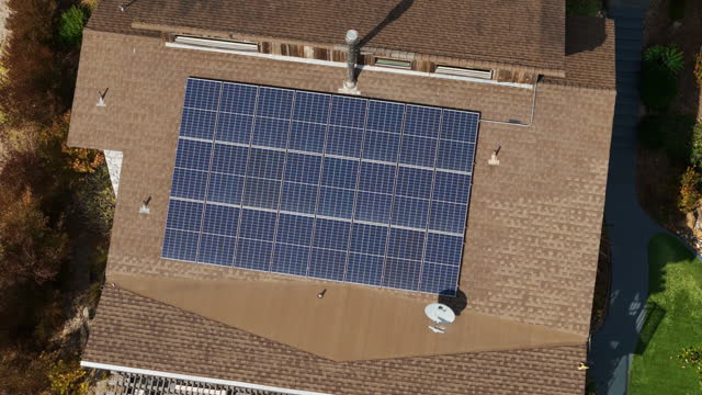 Solar panel installation on private countryside house. Top down Aerial footage