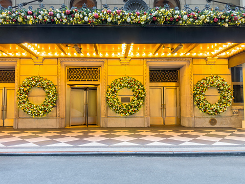 Outside view of a chic store entrance with Christmas ornaments in New York City