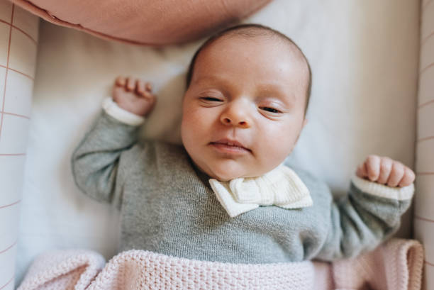 istock Newborn baby girl lying down in her crib at bedroom 1892963607