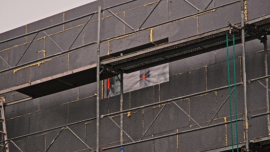 Construction Site Scaffolding by Building Wall During Thermo Modernization