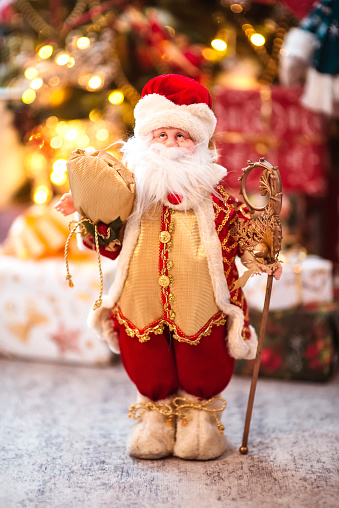 Toy Santa Claus on a background of Christmas lights. New Year. Father Frost