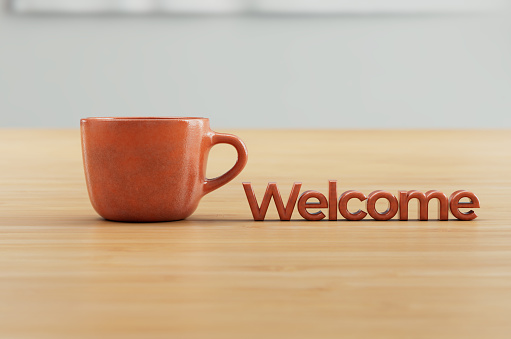Orange 3D rendered coffee cup on wood countertop with Welcome title.
