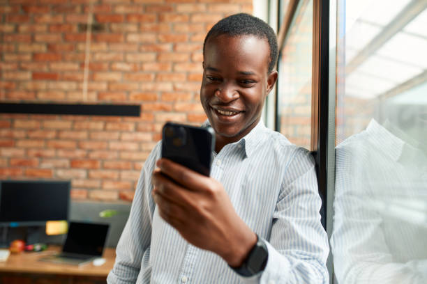 istock Happy young businessman using smartphone at office 1893100468