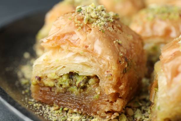 istock Delicious fresh baklava with chopped nuts on plate, closeup. Eastern sweets 1893105140
