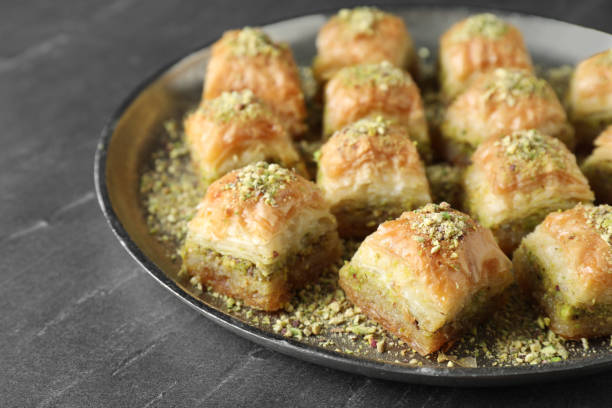 istock Delicious fresh baklava with chopped nuts on grey table, closeup. Eastern sweets 1893105648