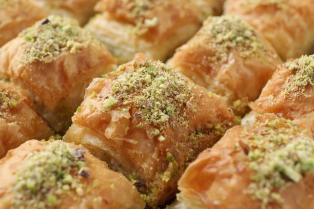 istock Delicious fresh baklava with chopped nuts as background, closeup. Eastern sweets 1893106538