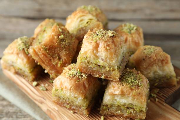 istock Delicious fresh baklava with chopped nuts on table, closeup. Eastern sweets 1893106707
