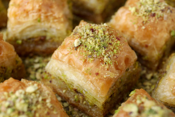 istock Delicious fresh baklava with chopped nuts on table, closeup. Eastern sweets 1893107753