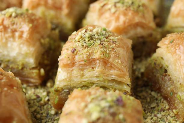 istock Delicious fresh baklava with chopped nuts on table, closeup. Eastern sweets 1893107762