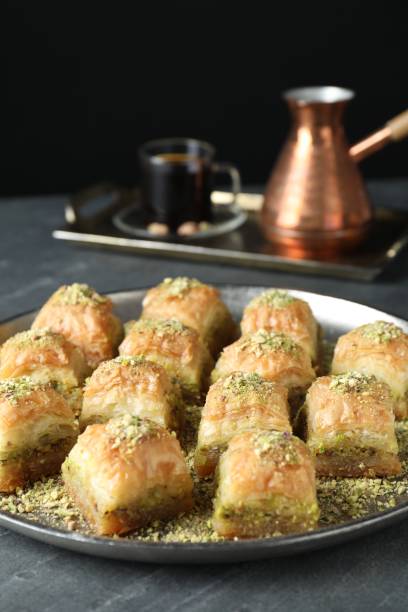 istock Delicious fresh baklava with chopped nuts on grey table. Eastern sweets 1893107767