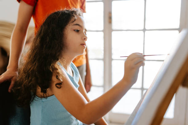 istock Little girl in canvas painting class 1893181319