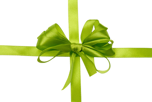 Tied bow from green silk ribbon on isolated background, decor for gift. Top view