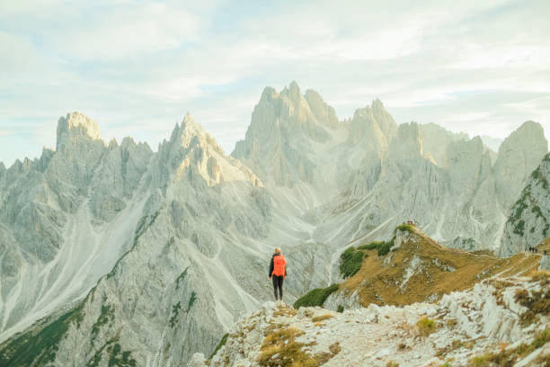 istock Young woman hikes up path in mountains 1893202923