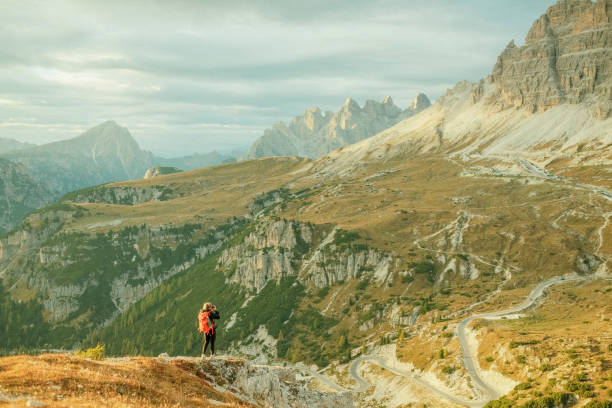 istock Young woman hikes up path in mountains 1893202939