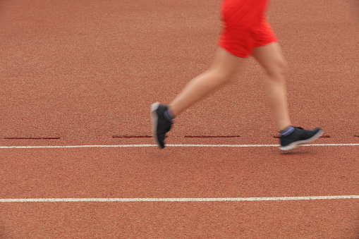 Long distance runners are running on the track