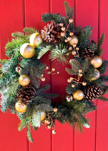 Green Christmas Wreath, Pinecones, Berries, Rustic Wood Door. Shot in Santa Fe, NM.