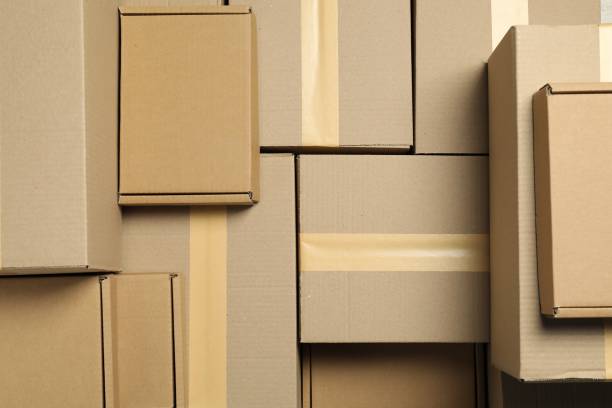 istock Many cardboard boxes as background, top view. Packaging goods 1893243269