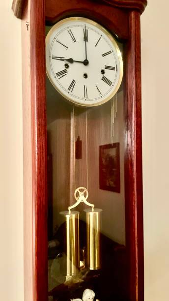 istock Antique old wooden clock with big gold pendulum 1893243797